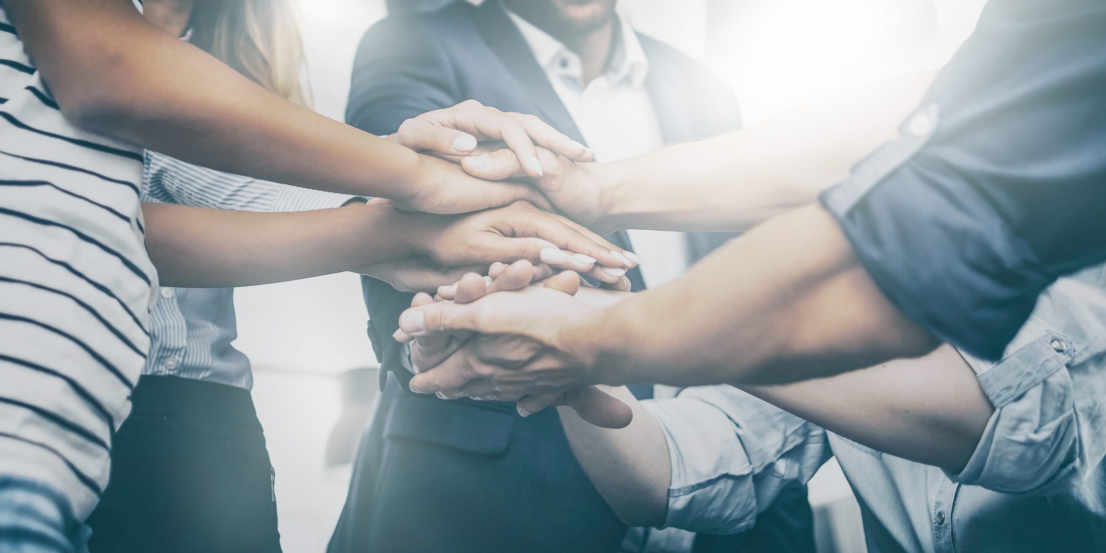 Close,Up,View,Of,Young,Business,People,Putting,Their,Hands