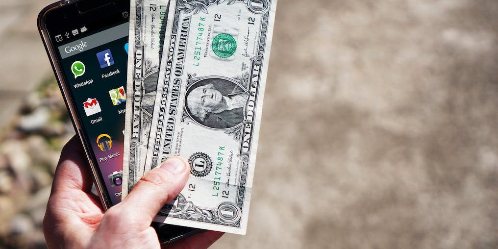 mobile-phone-money-banknotes-us-dollars-163069